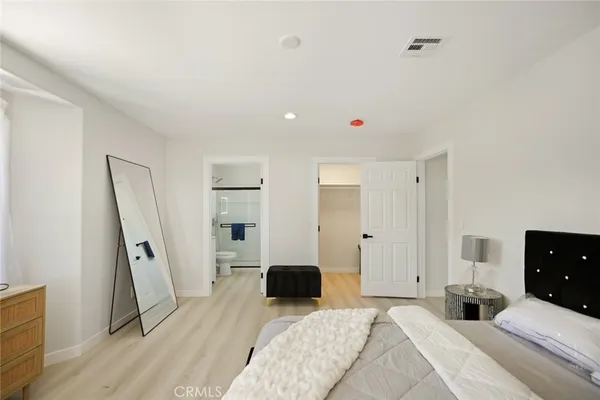 a bedroom with a bed and a dresser