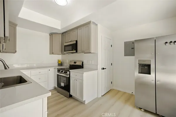 a kitchen with a sink a stove and refrigerator