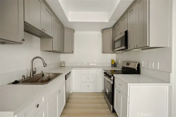a kitchen with stainless steel appliances granite countertop a sink stove a microwave and refrigerator