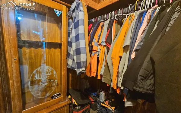 a view of walk in closet with clothes