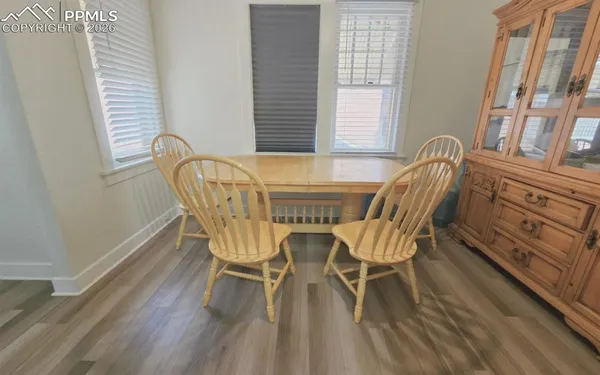 a view of a dining room with furniture and wooden floor