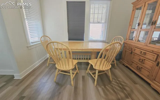 a view of a dining room with furniture and wooden floor
