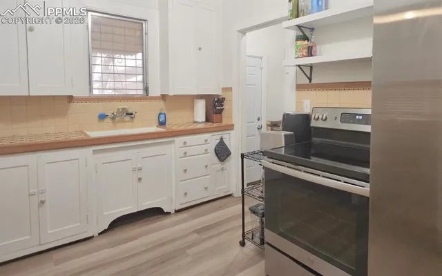 a kitchen with cabinets appliances and a window