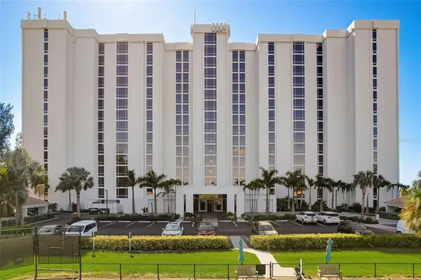 a building with swimming pool and outdoor seating