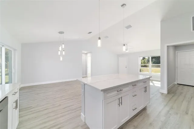 an empty room with a empty space and a ceiling fan