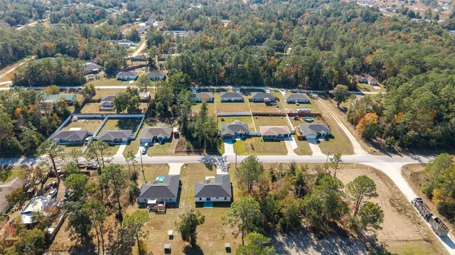 a view of a house with swimming pool and sitting area