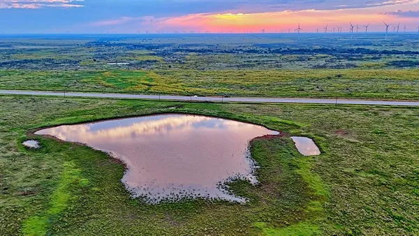 a view of a lake with a yard and mountain