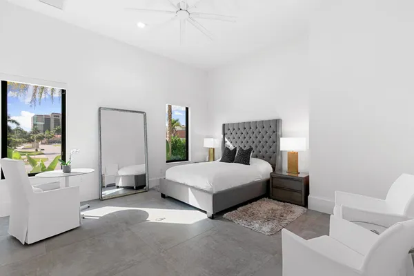 a living room with patio furniture and a garden