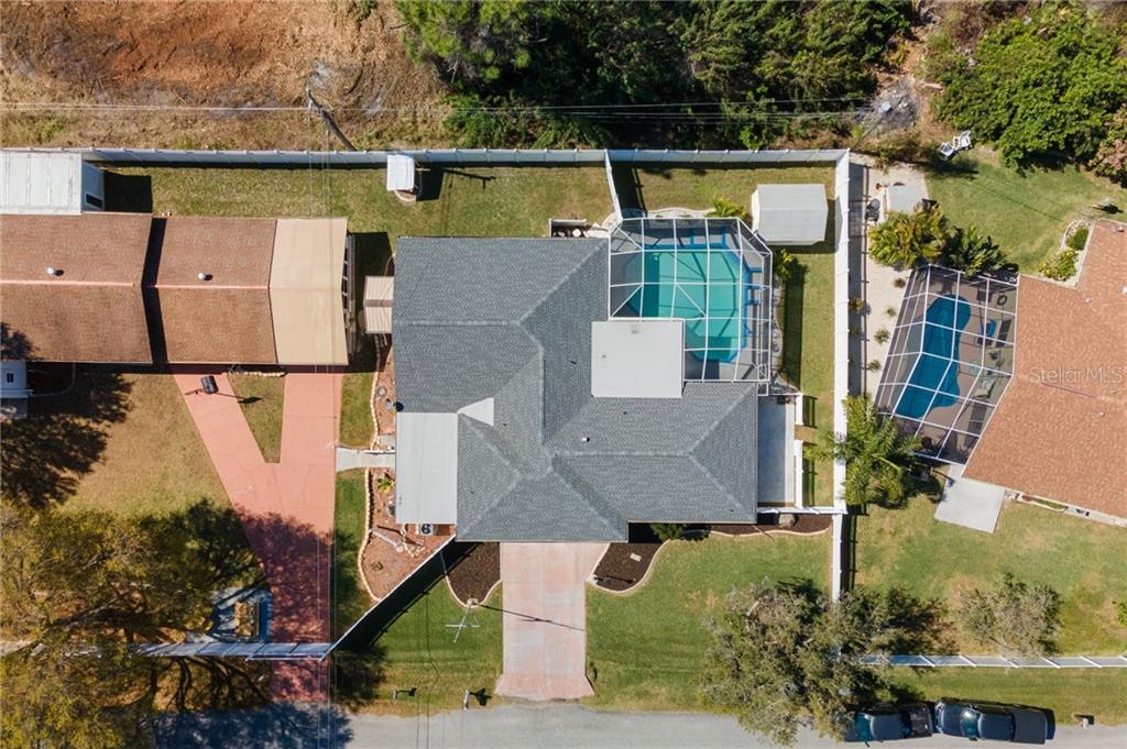 an aerial view of residential house with outdoor space and swimming pool