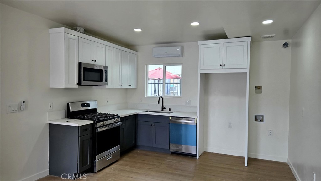 11171 Bullis Road Lynwood, CA 90262 - Photo 2 of 15 a kitchen with stainless steel appliances granite countertop a sink and a stove