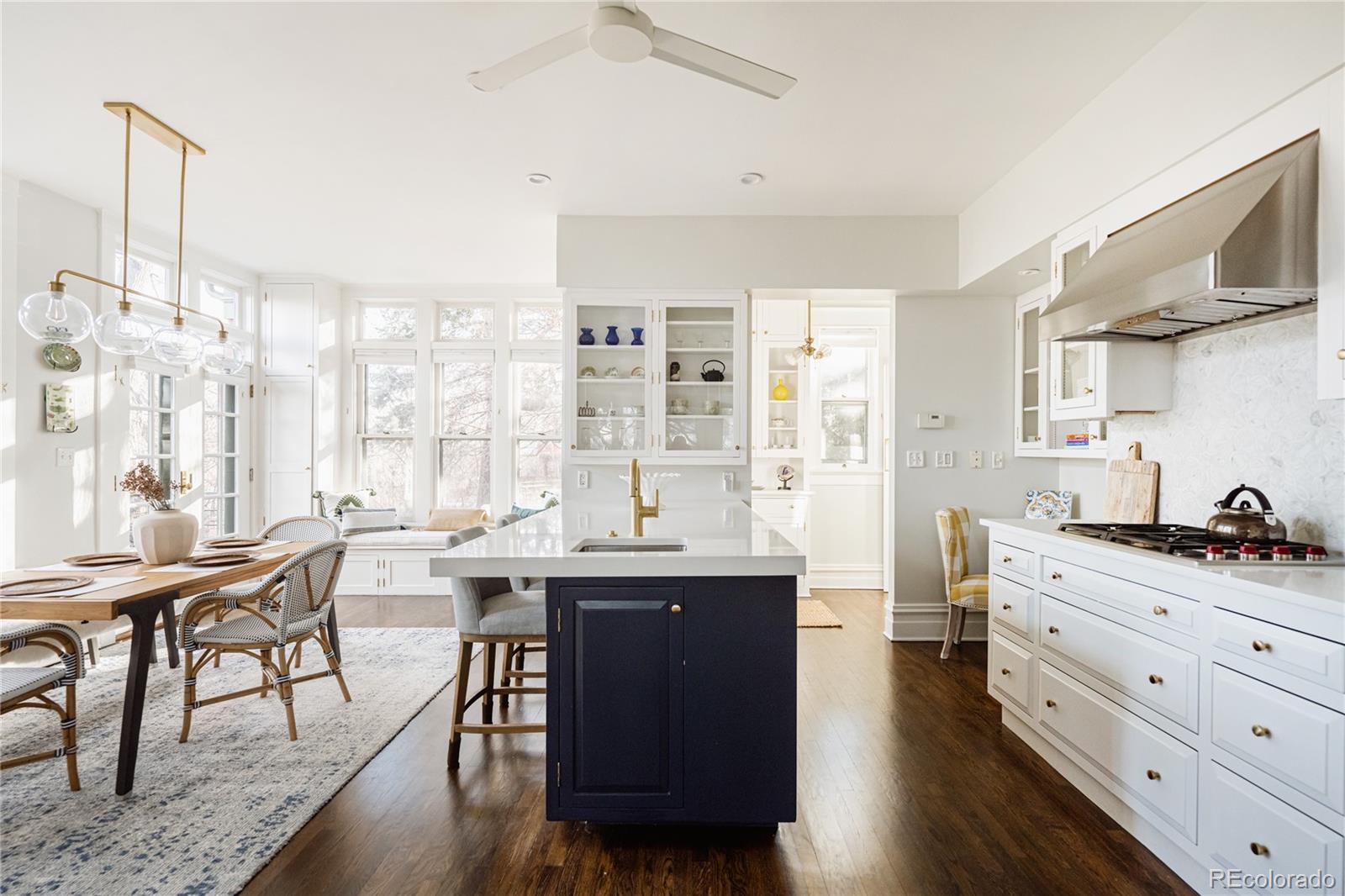 870 12th Street Boulder, CO 80302 - Photo 15 of 34 a room with stainless steel appliances kitchen island granite countertop a table chairs in it and wooden floors