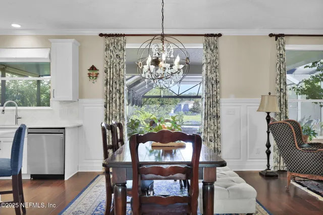 a living room with furniture kitchen view and a window