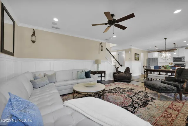 a view of a livingroom with furniture and staircase