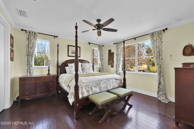 a spacious bathroom with a double vanity sink a large mirror a bathtub and next to a window