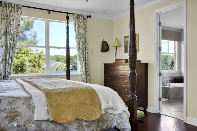 a bathroom with a tub a sink and glass door shower