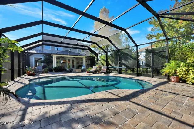 an aerial view of a city with lots of residential buildings ocean and mountain view in back