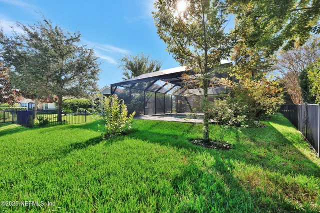 an aerial view of a house with swimming pool and garden