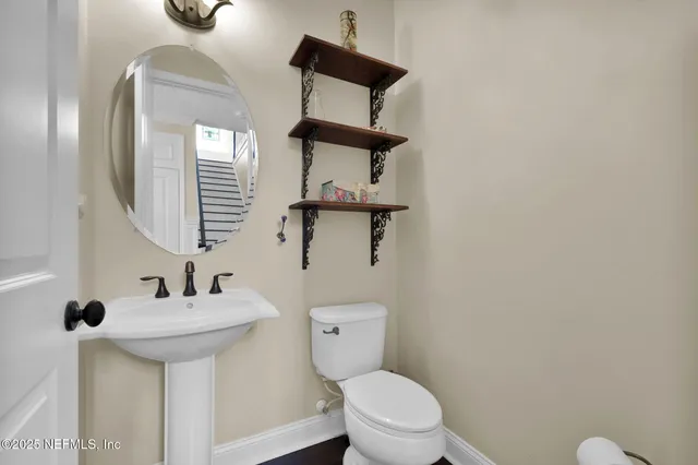 a kitchen with stainless steel appliances a table chairs refrigerator and microwave