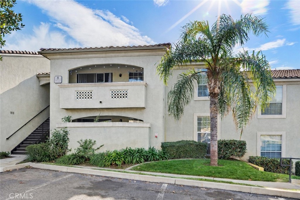 375 Central Avenue, Unit 78 Riverside, CA 92507 - Photo 1 of 43 a view of a white house with a yard and palm trees