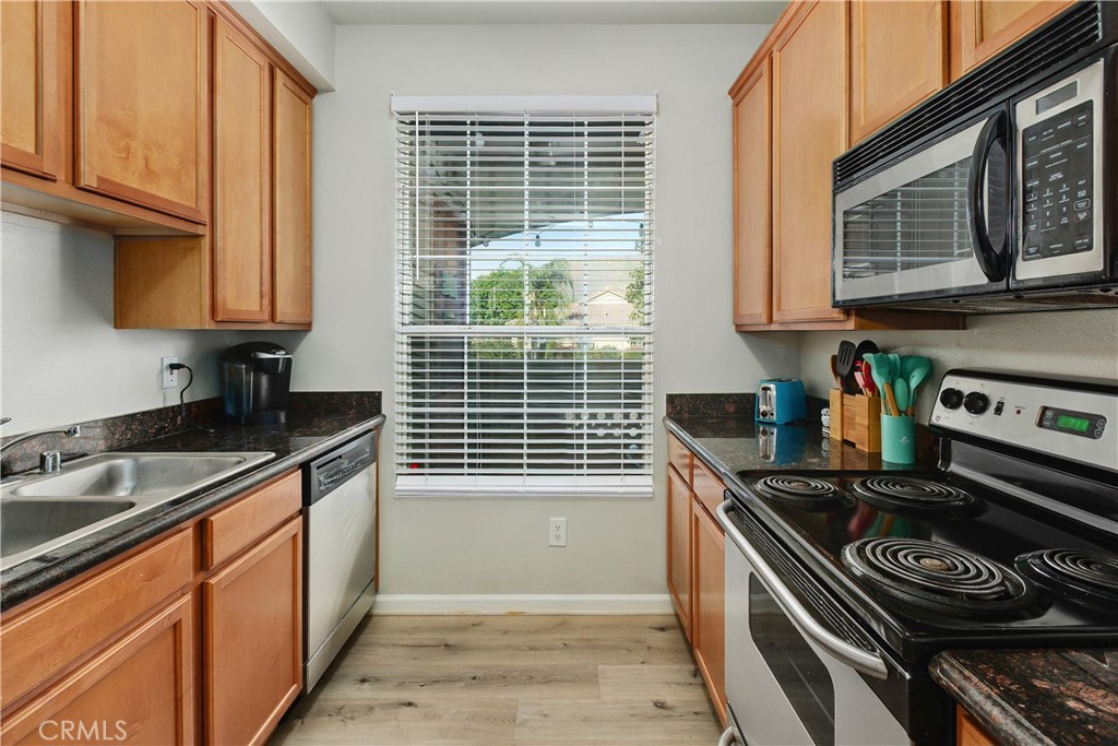 375 Central Avenue, Unit 78 Riverside, CA 92507 - Photo 11 of 43 a kitchen with stainless steel appliances granite countertop a sink stove and cabinets