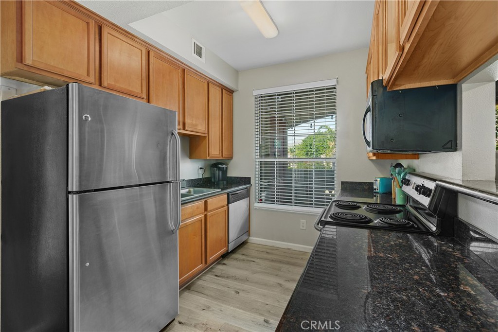 375 Central Avenue, Unit 78 Riverside, CA 92507 - Photo 12 of 43 a kitchen with stainless steel appliances a refrigerator sink and cabinets