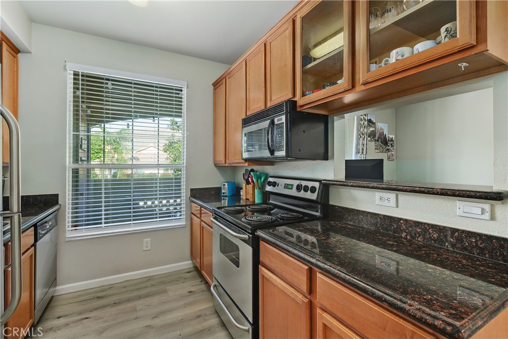 375 Central Avenue, Unit 78 Riverside, CA 92507 - Photo 13 of 43 a kitchen with stainless steel appliances granite countertop a stove and a microwave