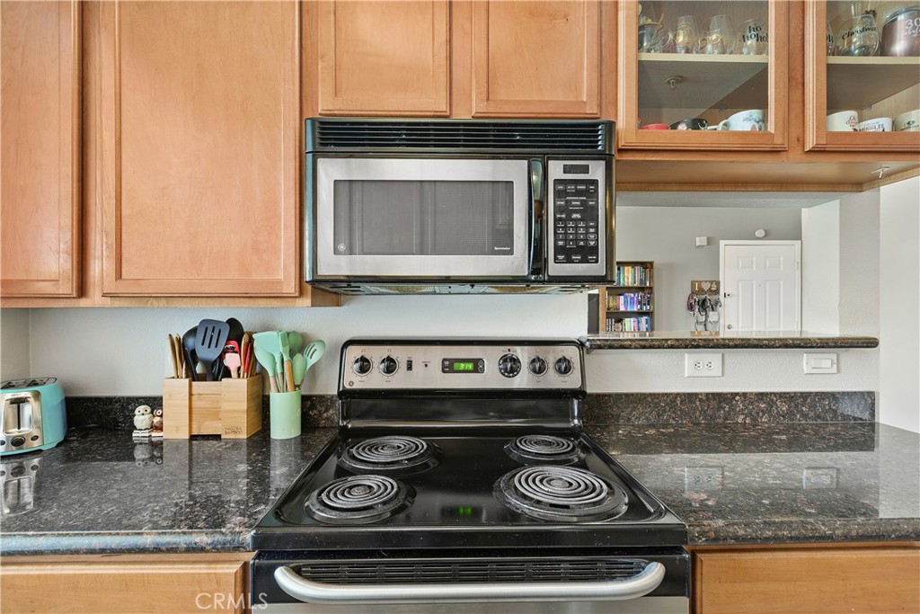 375 Central Avenue, Unit 78 Riverside, CA 92507 - Photo 14 of 43 a kitchen with granite countertop stainless steel appliances stove and cabinets