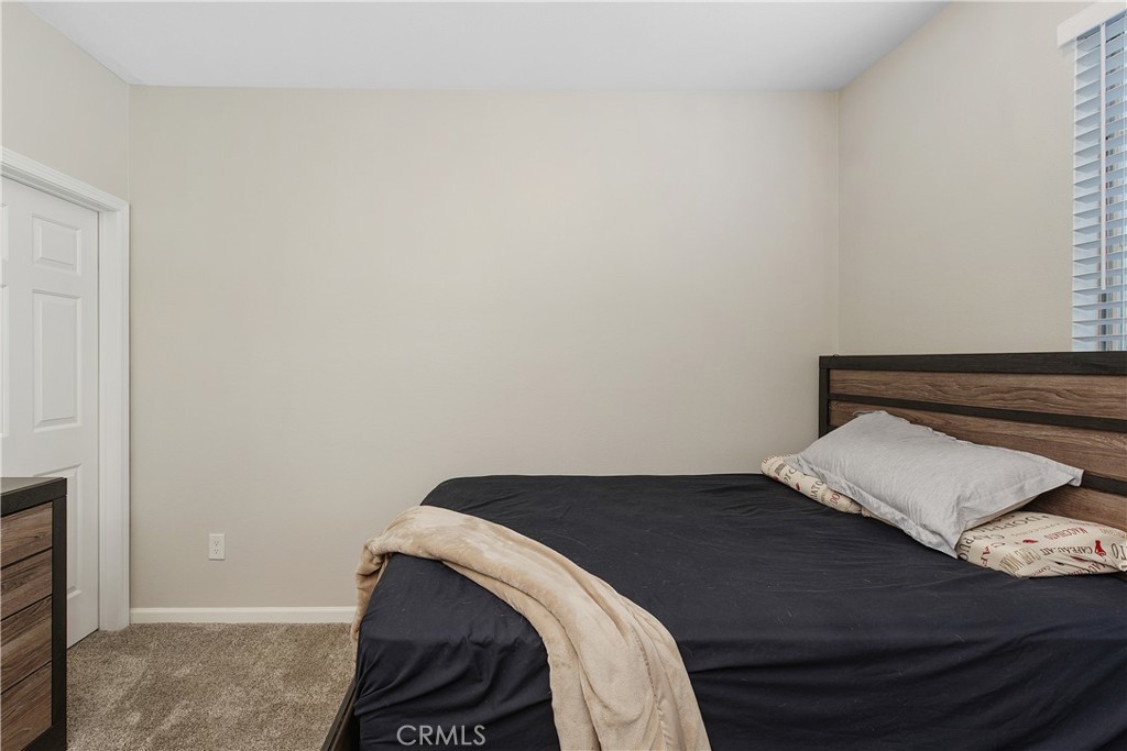 375 Central Avenue, Unit 78 Riverside, CA 92507 - Photo 18 of 43 a bedroom with a bed and a night stand