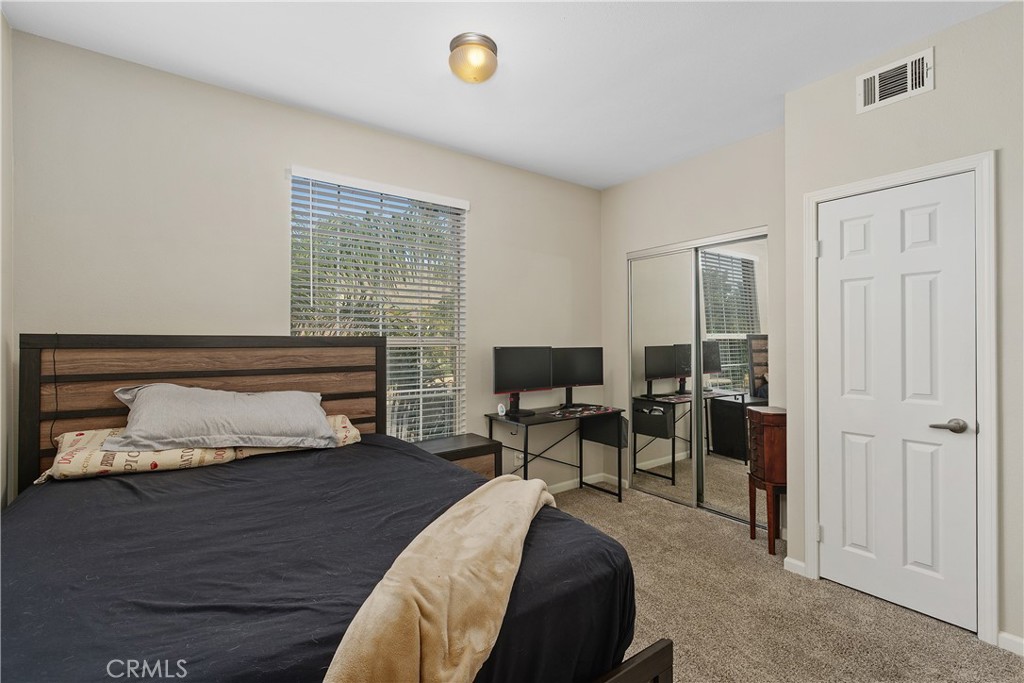 375 Central Avenue, Unit 78 Riverside, CA 92507 - Photo 19 of 43 a bedroom with furniture and a wooden floor