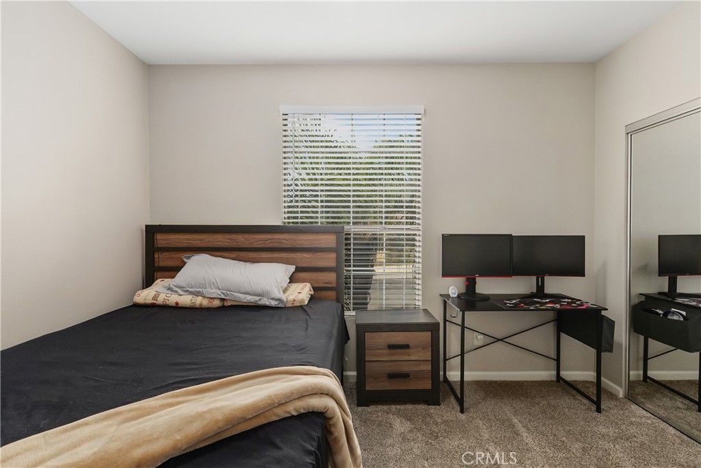 375 Central Avenue, Unit 78 Riverside, CA 92507 - Photo 21 of 43 a bedroom with a bed and a chair