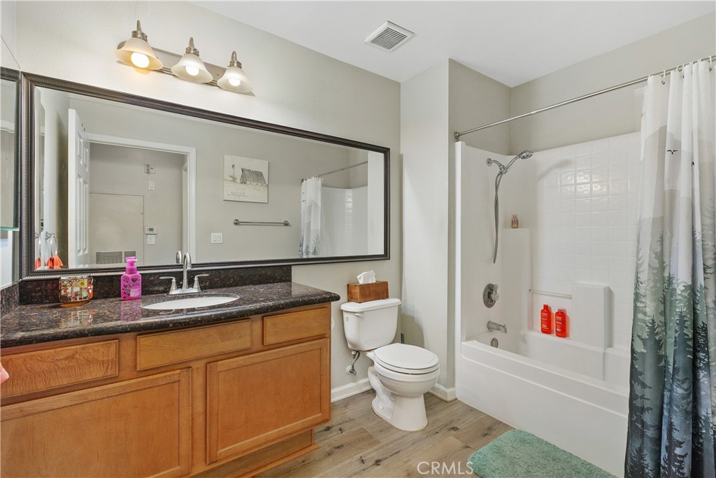 375 Central Avenue, Unit 78 Riverside, CA 92507 - Photo 23 of 43 a bathroom with a granite countertop sink mirror vanity and toilet