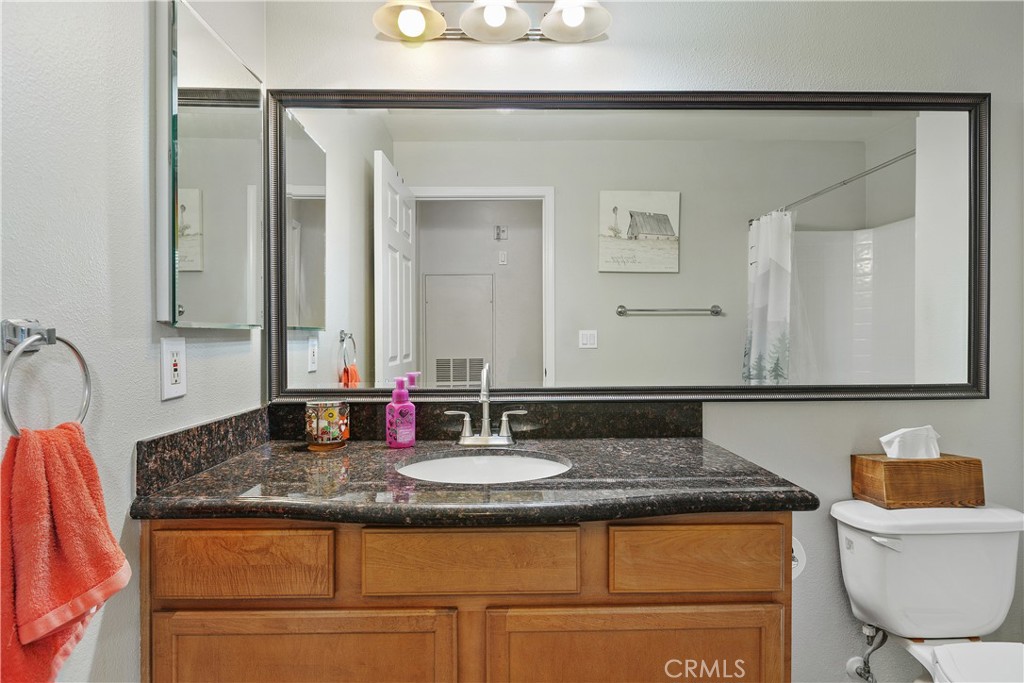 375 Central Avenue, Unit 78 Riverside, CA 92507 - Photo 24 of 43 a bathroom with a granite countertop sink and a mirror