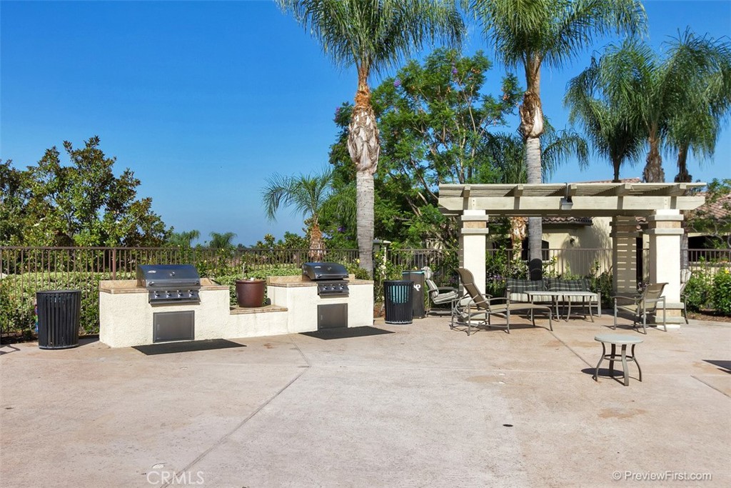 375 Central Avenue, Unit 78 Riverside, CA 92507 - Photo 32 of 43 a view of a patio with a table and chairs under an umbrella