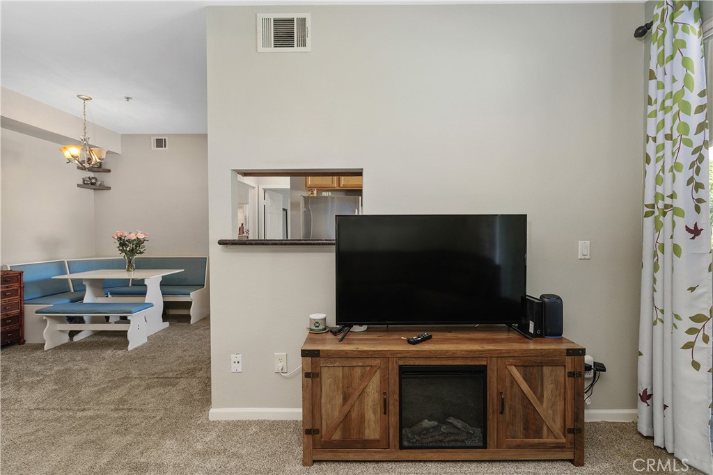375 Central Avenue, Unit 78 Riverside, CA 92507 - Photo 8 of 43 a living room with furniture and a flat screen tv