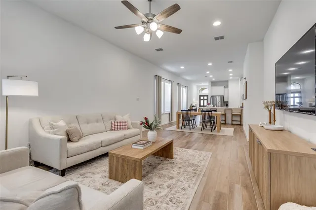 a living room with furniture and a view of kitchen
