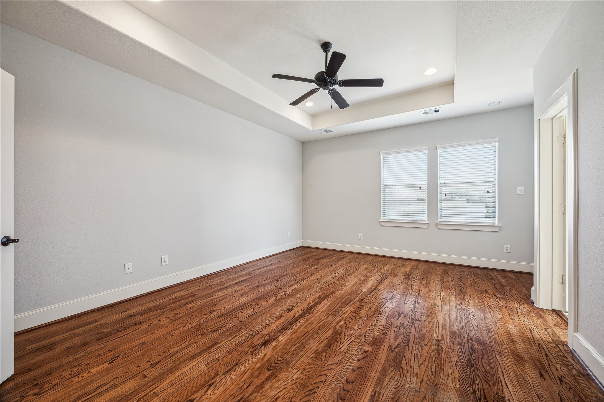 303 Bethje Street Houston, TX 77007 - Photo 12 of 25 a view of empty room with wooden floor and fan