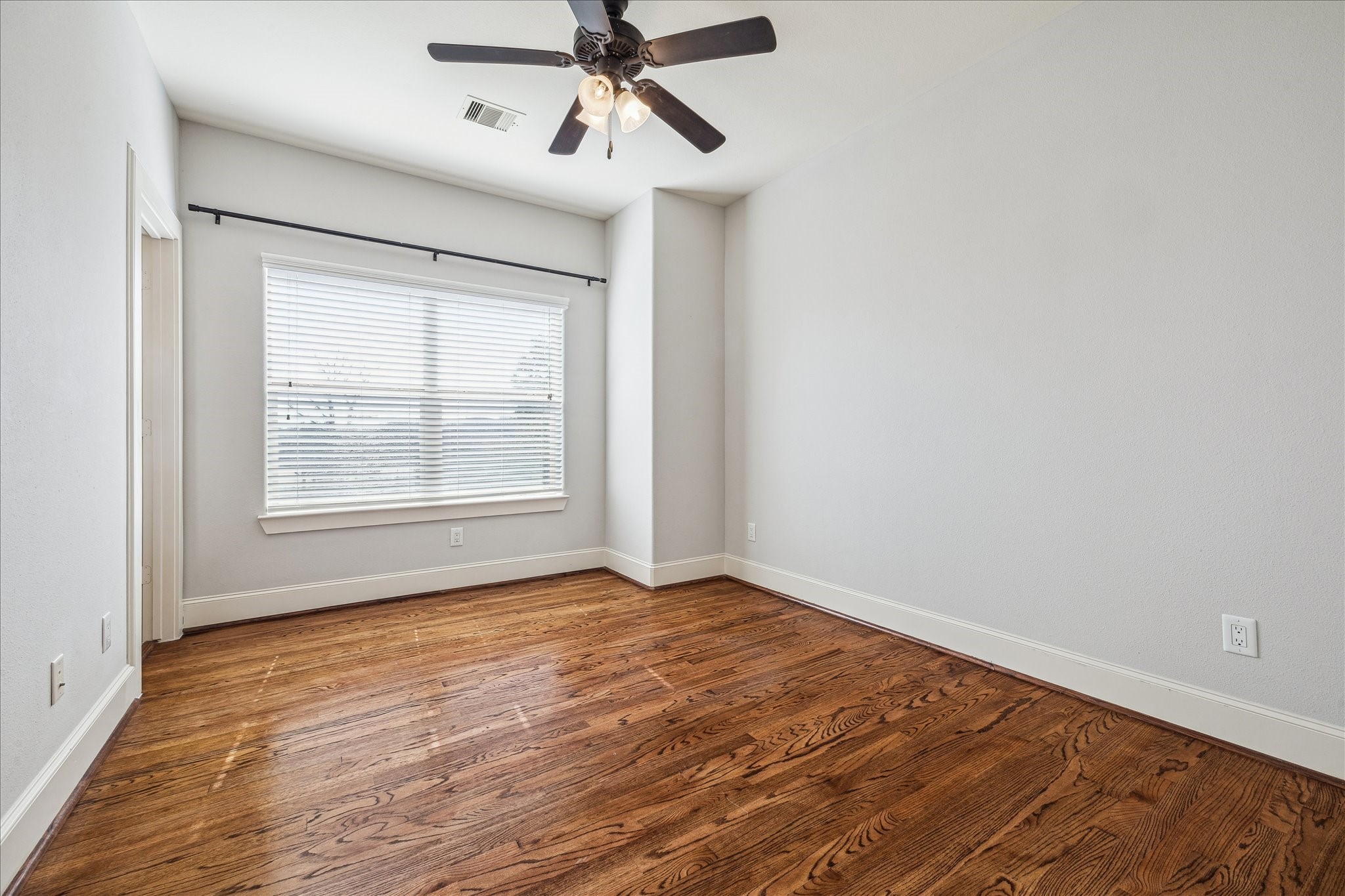 303 Bethje Street Houston, TX 77007 - Photo 16 of 25 wooden floor in an empty room with a window