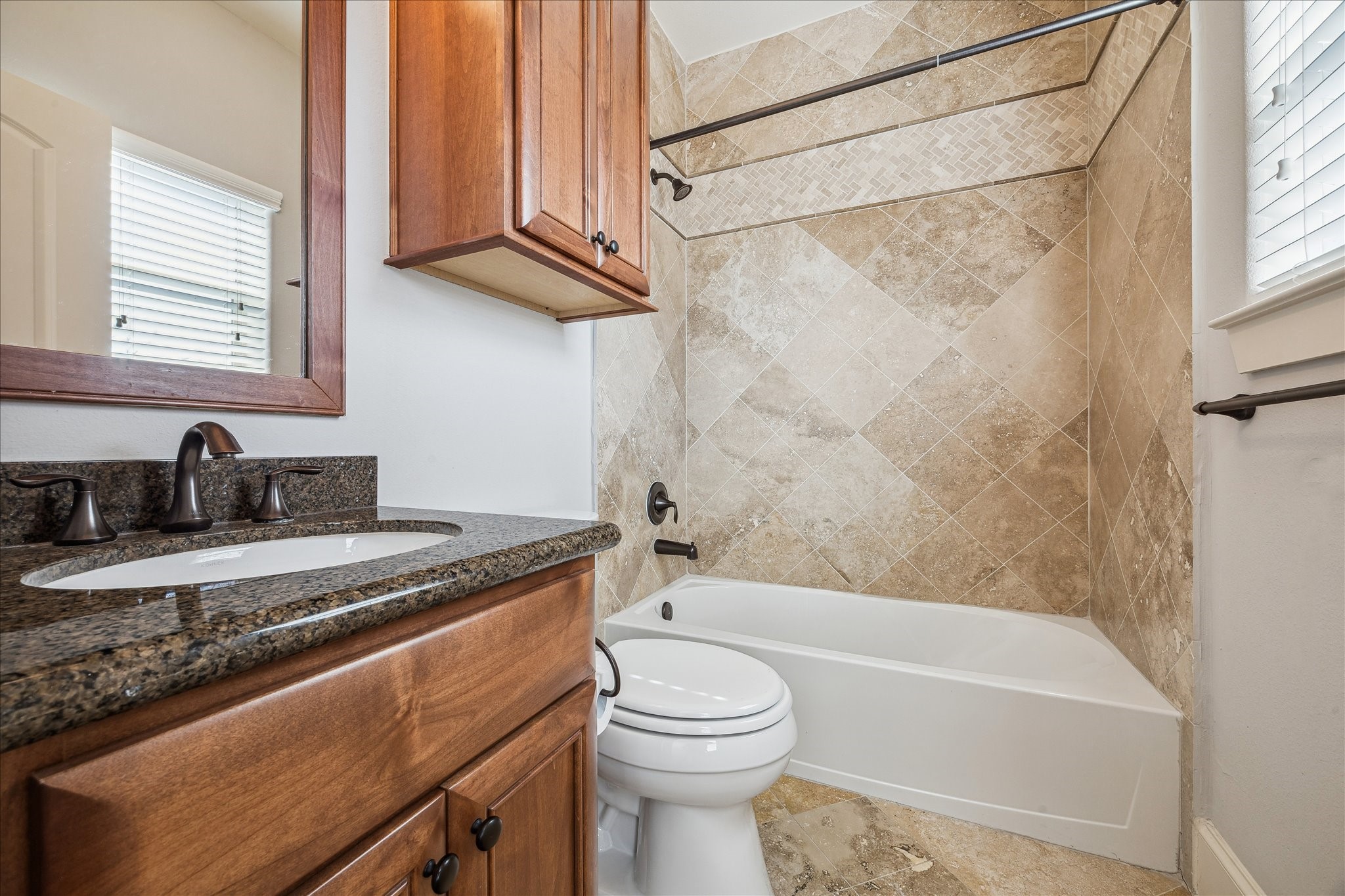 303 Bethje Street Houston, TX 77007 - Photo 17 of 25 a bathroom with a granite countertop sink a toilet and bathtub