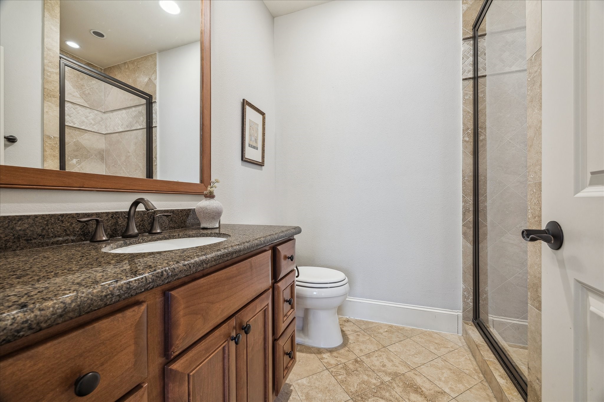 303 Bethje Street Houston, TX 77007 - Photo 20 of 25 a bathroom with a granite countertop sink a toilet and a mirror