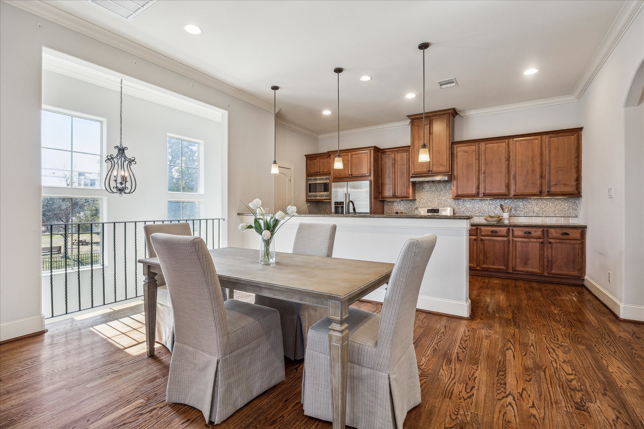 303 Bethje Street Houston, TX 77007 - Photo 2 of 25 a view of a dining room and livingroom with furniture wooden floor a chandelier