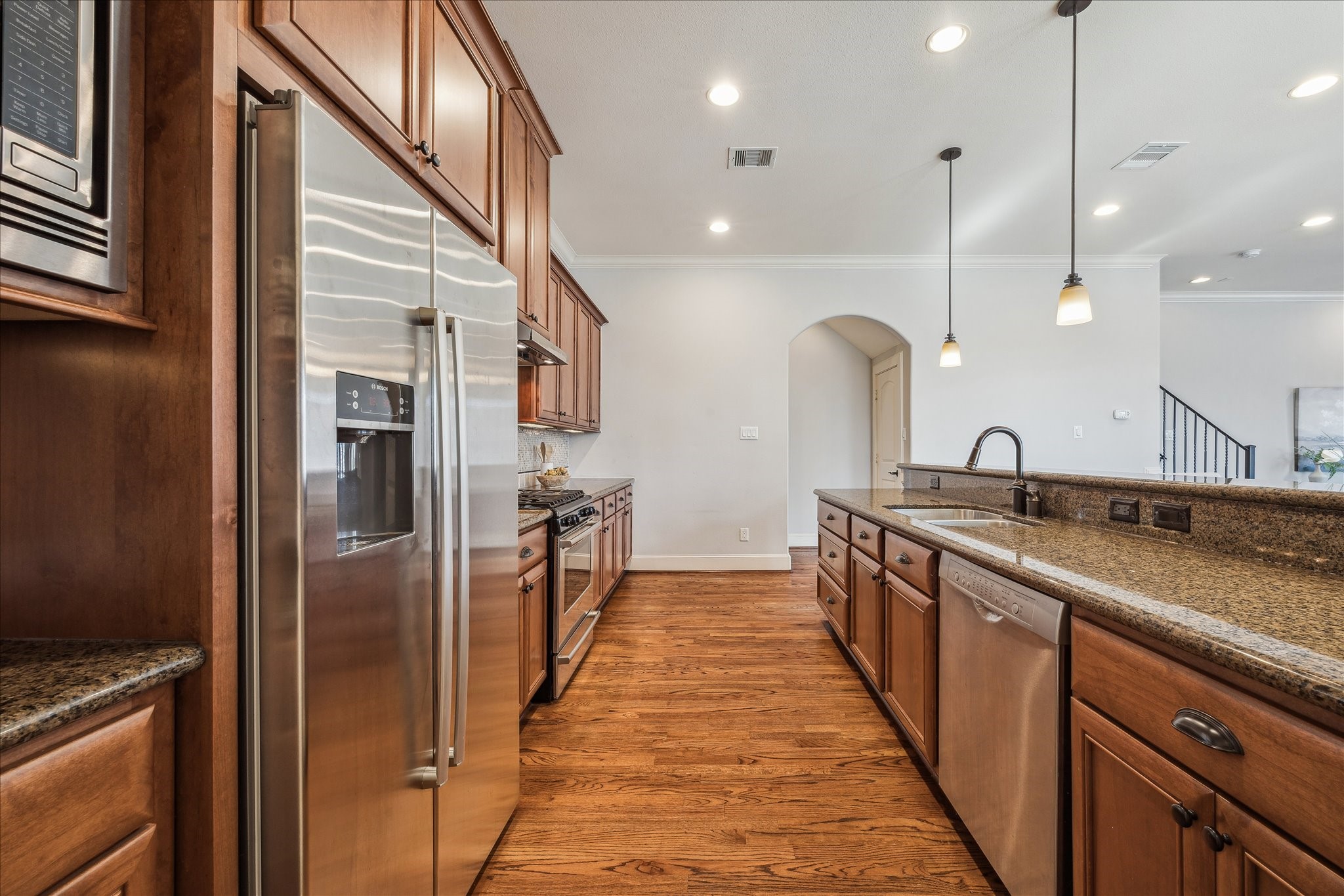303 Bethje Street Houston, TX 77007 - Photo 9 of 25 a kitchen with stainless steel appliances a sink and a refrigerator