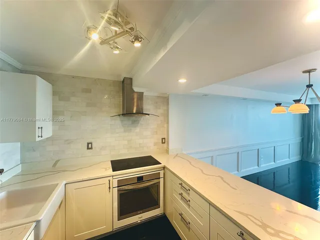 a kitchen with a sink and a stove top oven