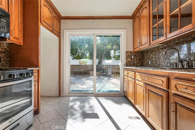 a view of a kitchen with a sink and a stove