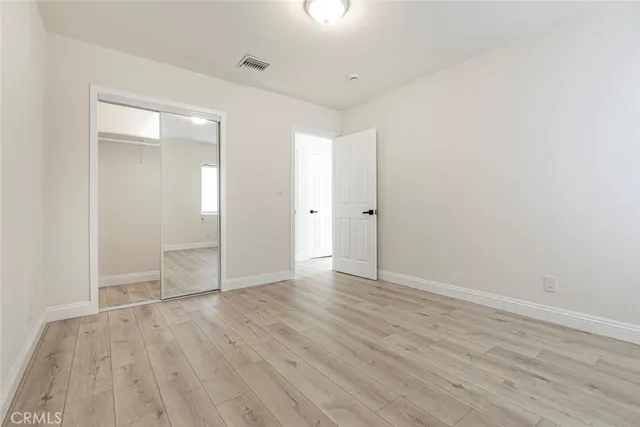 a view of an empty room and wooden floor