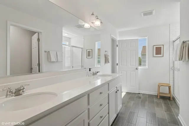 a spacious bathroom with a double vanity sink mirror and
