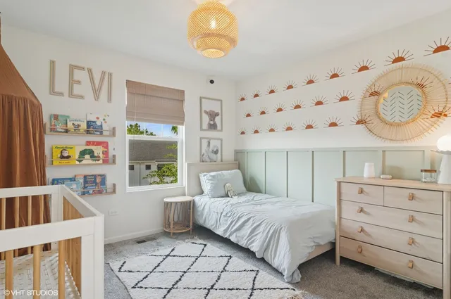 a bedroom with a bed a window and dresser