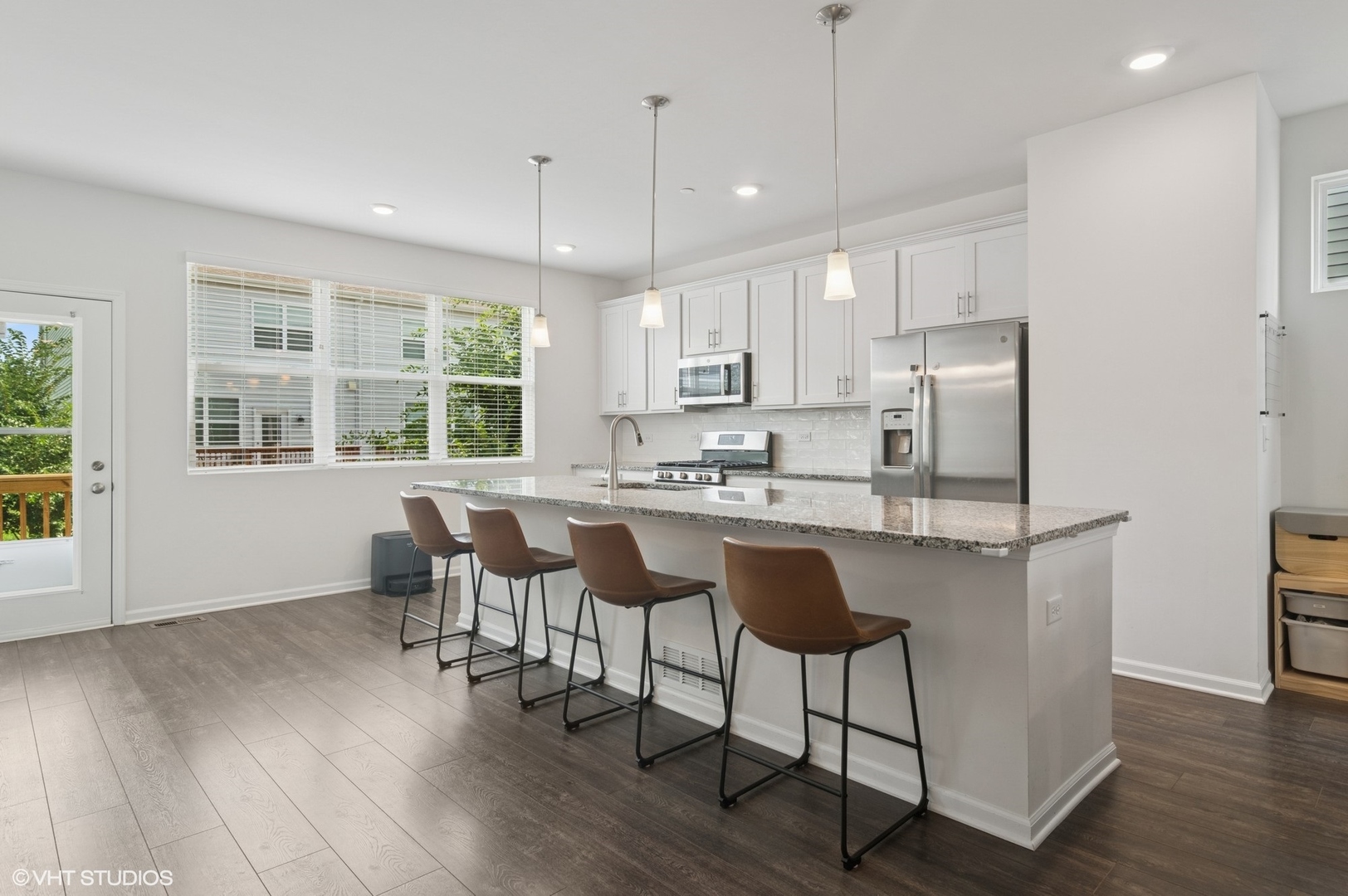 2709 Lily Lane Rolling Meadows, IL 60008 - Photo 8 of 18 a kitchen with stainless steel appliances granite countertop a stove a refrigerator a sink a dining table and chairs with wooden floor