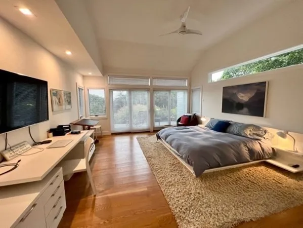 a bedroom with two beds and a flat screen tv