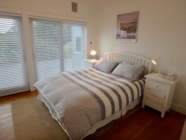 a bedroom with a bed and a lamp