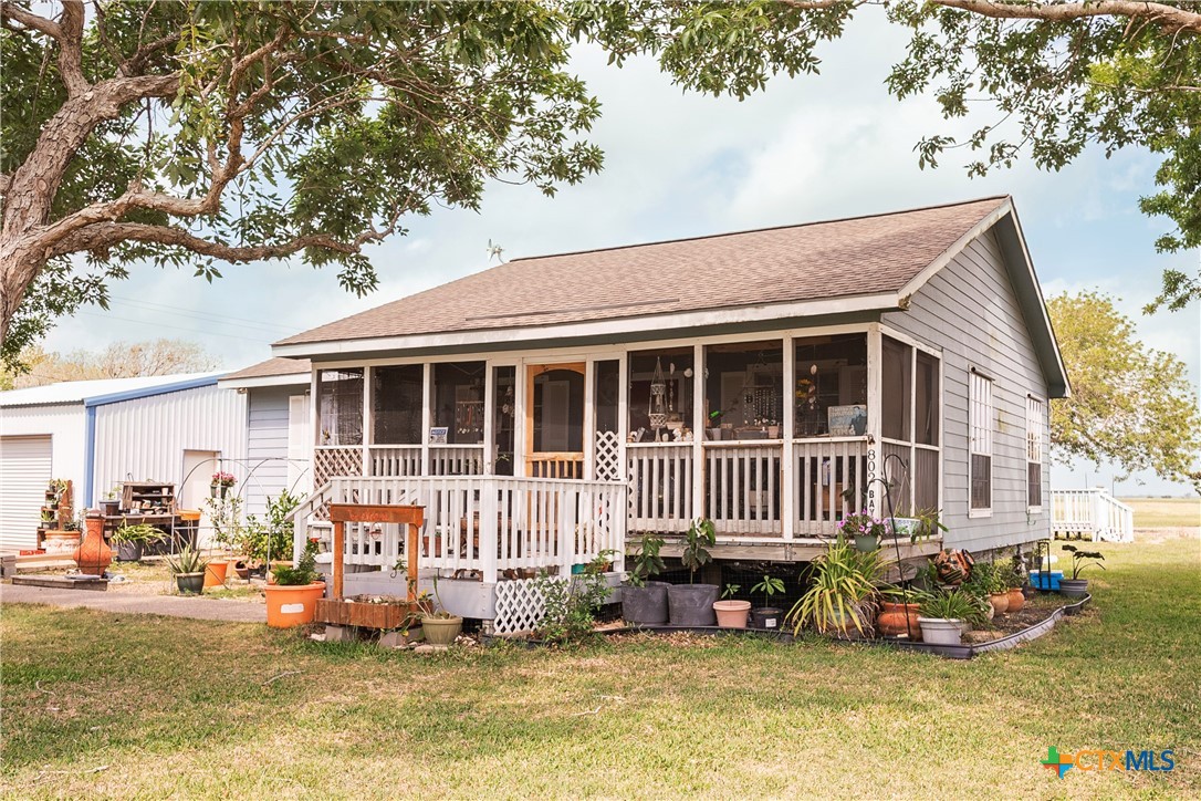 a front view of a house with a yard balcony